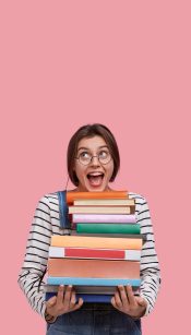 Studio shot of joyful European woman wears round spectacles, holds many books, opens mouth from excitement, poses against pink background with free space for your advertisement or promotion. Studio shot of joyful European woman wears round spectacles, holds many books, opens mouth from excitement, poses against pink background with free space for your advertisement or promotion.