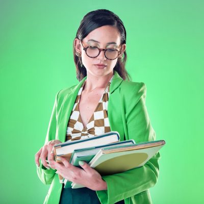 woman-teacher-and-books-with-reading-in-studio-g-2023-11-27-05-03-49-utc Woman, teacher and books with reading in studio, green screen or background with thinking for caree.